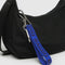 cobalt keychain with dark blue 'baggu' font attached to a purse