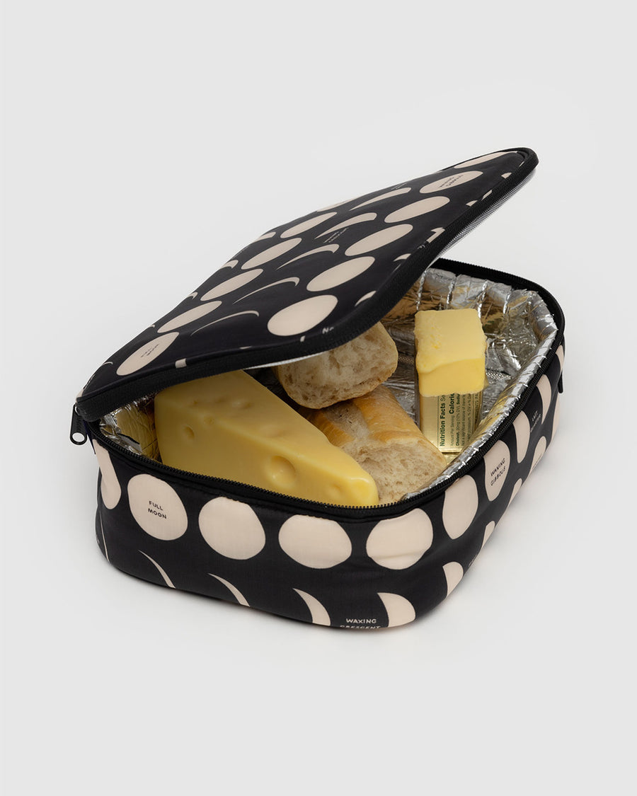 black lunch box with cream moon. phase print with food inside