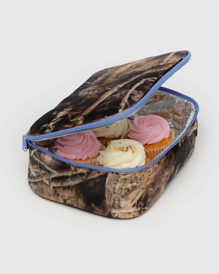 lunch box with realistic forest print with cornflower trim with cupcakes inside