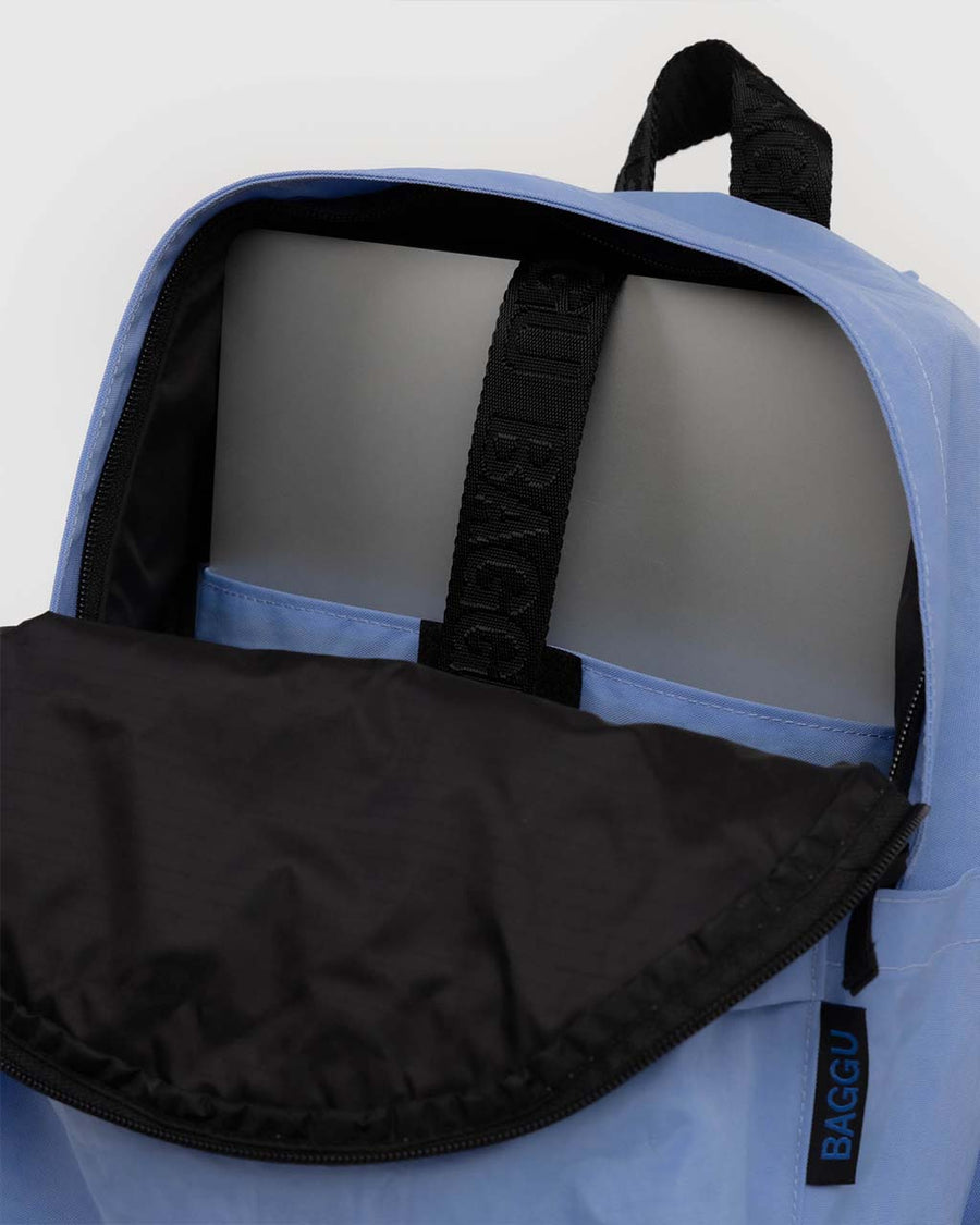 interior of cornflower medium nylon backpack with large zipper compartment, front zipper pocket, and side drink holder