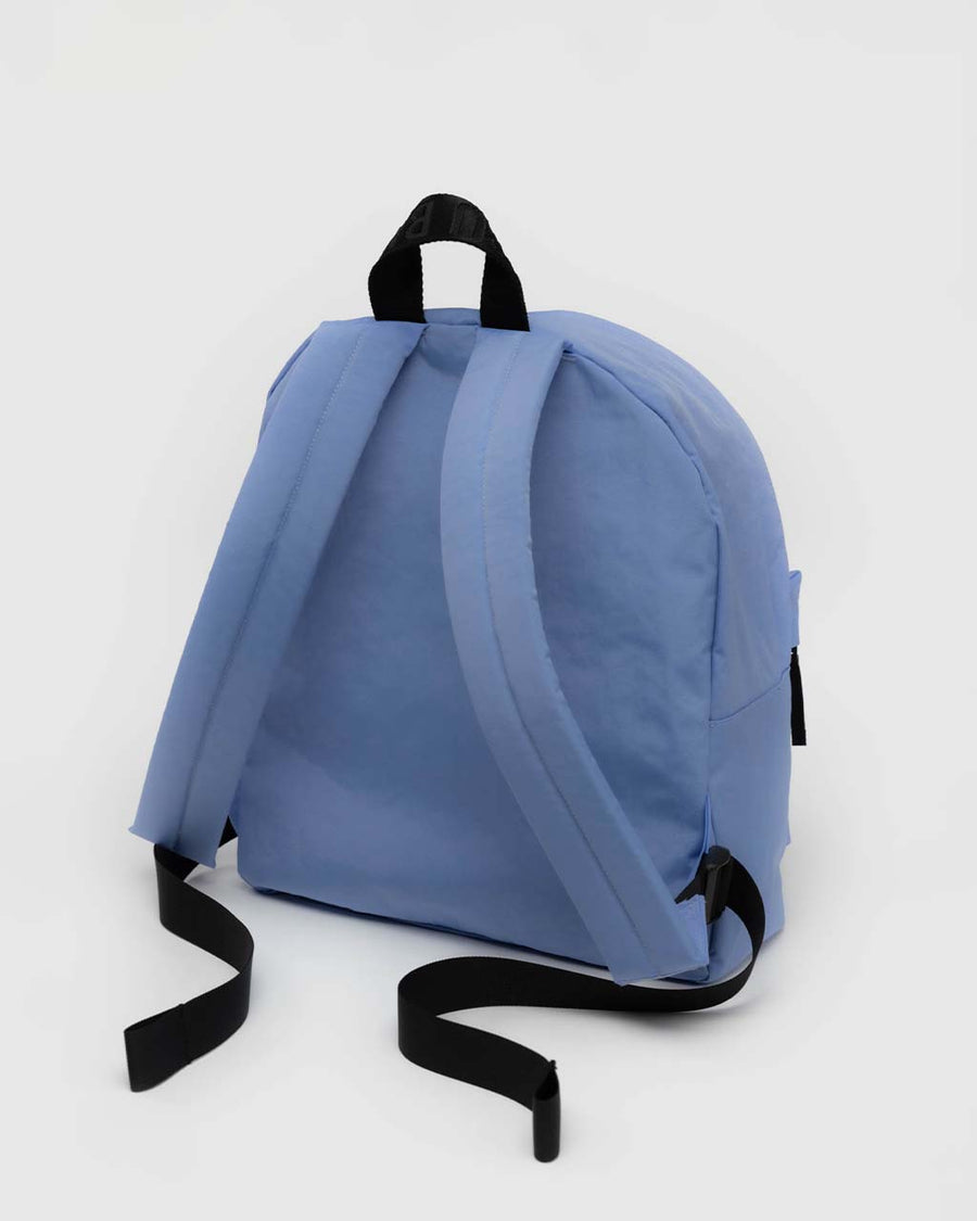 back view of cornflower medium nylon backpack with large zipper compartment, front zipper pocket, and side drink holder