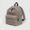 taupe medium nylon backpack with large zipper compartment, front zipper pocket, and side drink holder