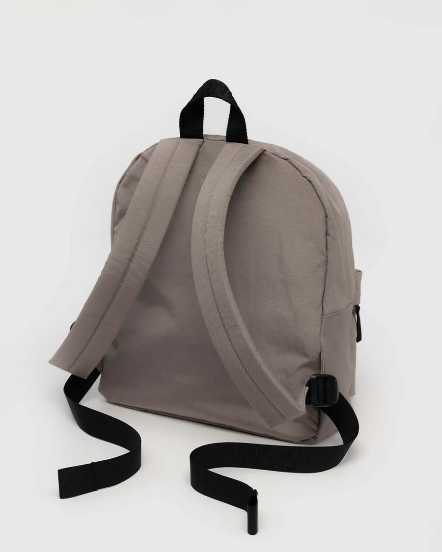 back view of taupe medium nylon backpack with large zipper compartment, front zipper pocket, and side drink holder