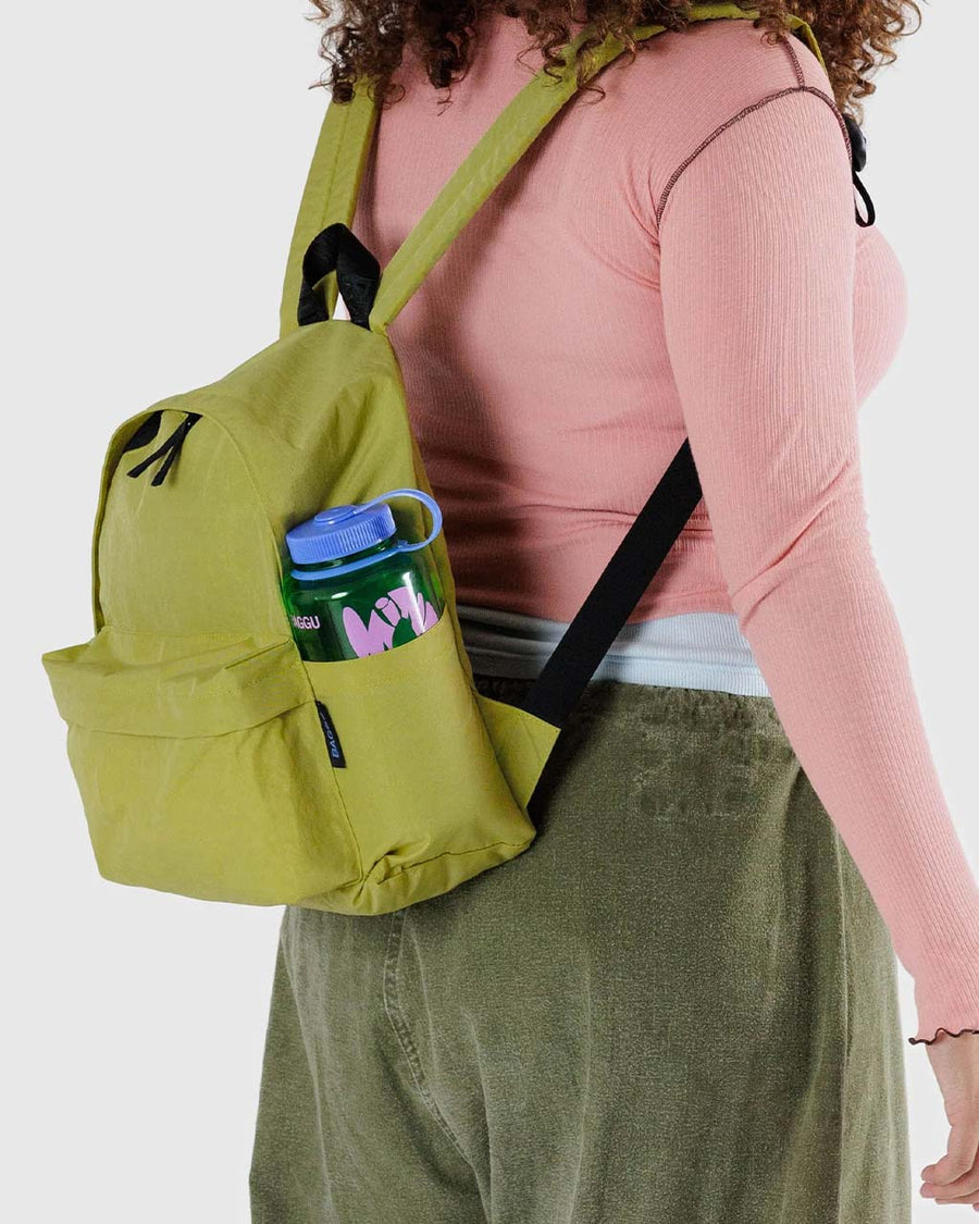 model wearing lime green medium nylon backpack