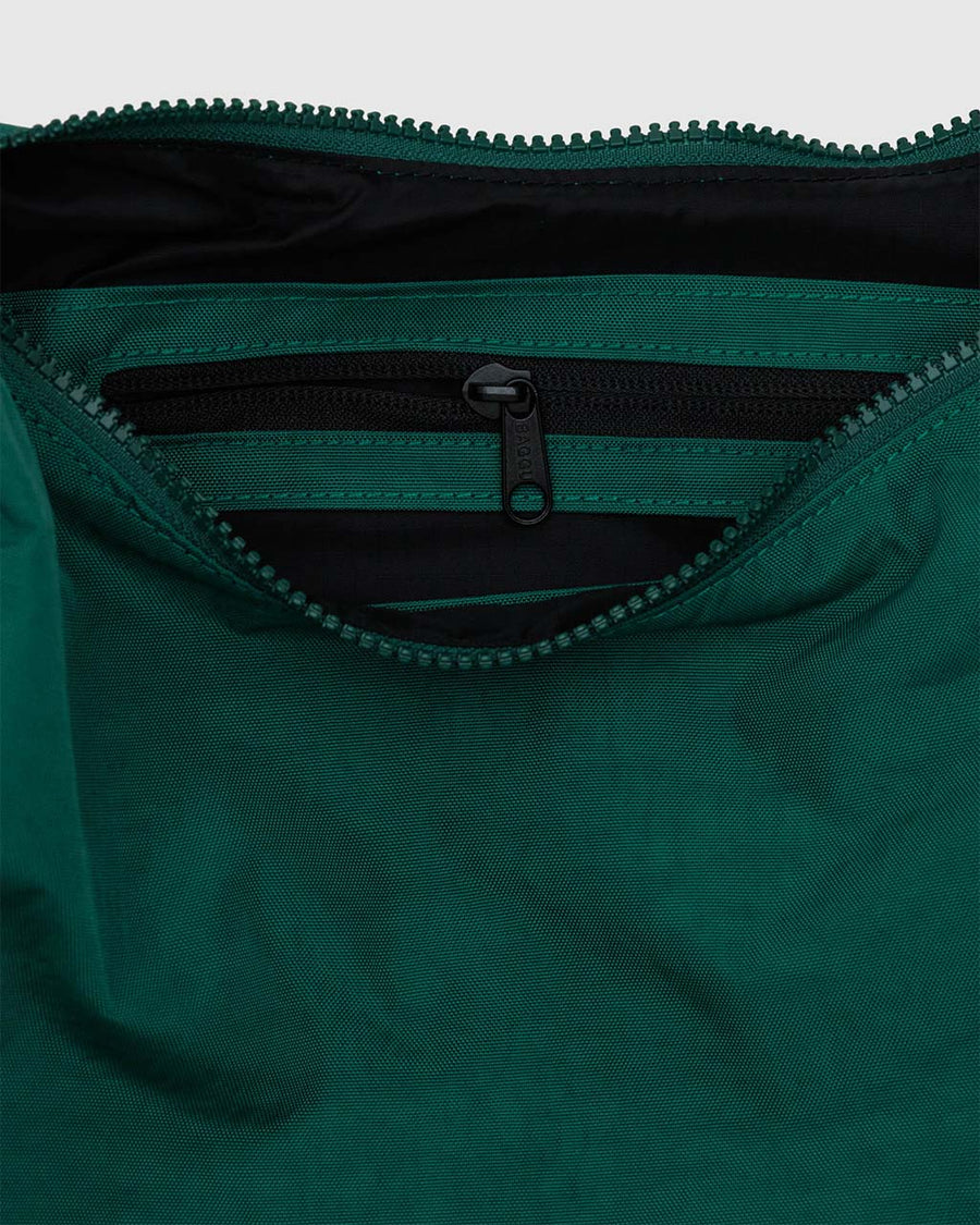 interior pocket of cypress green medium nylon crescent bag with tonal strap