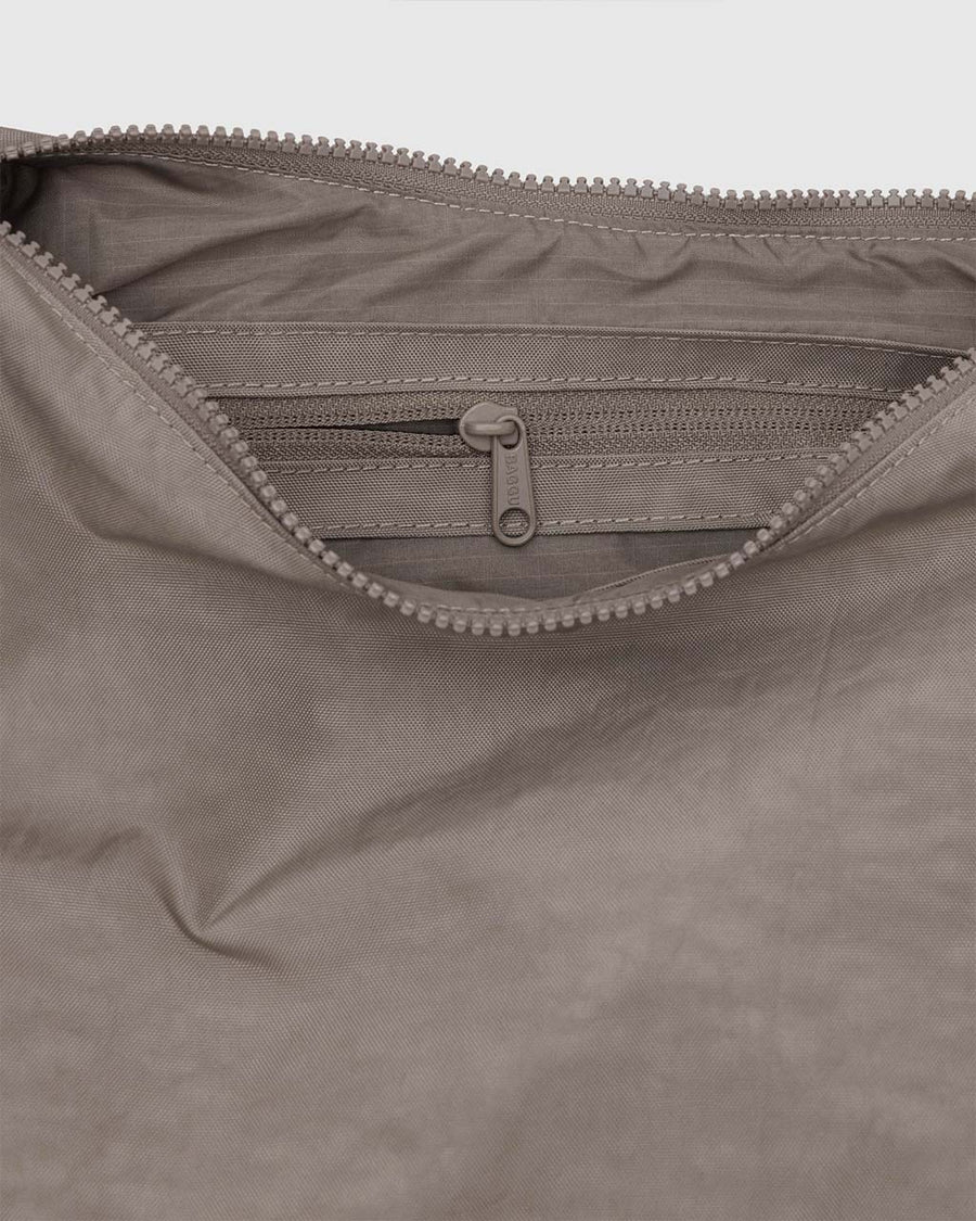 interior pocket of taupe medium nylon crescent bag with tonal strap