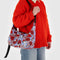 model carrying periwinkle medium crescent bag with joe cool and floral print