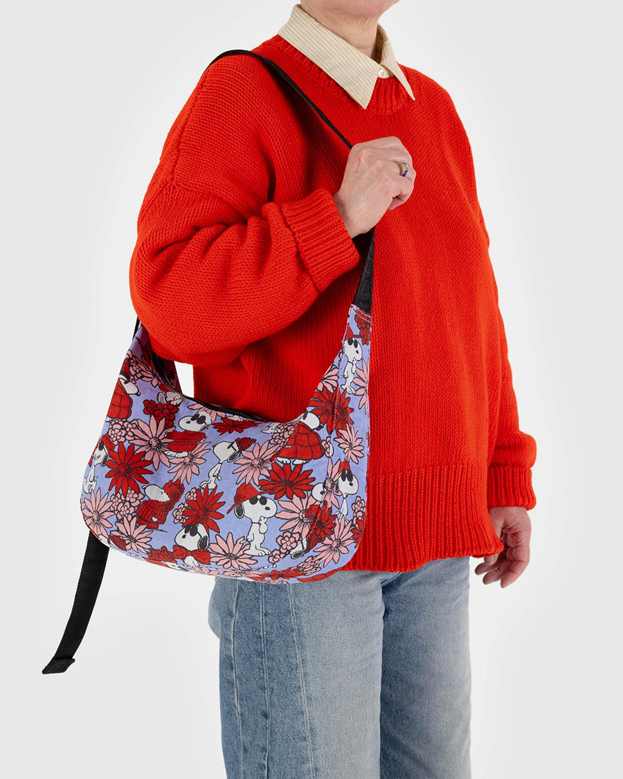 model carrying periwinkle medium crescent bag with joe cool and floral print