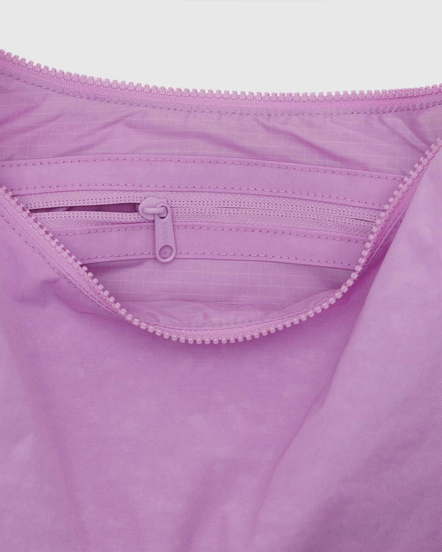 interior pocket of peony pink medium nylon crescent bag with tonal strap