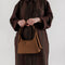 model holding brown mini nylon shoulder bag