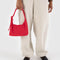 model holding candy apple red mini nylon shoulder bag