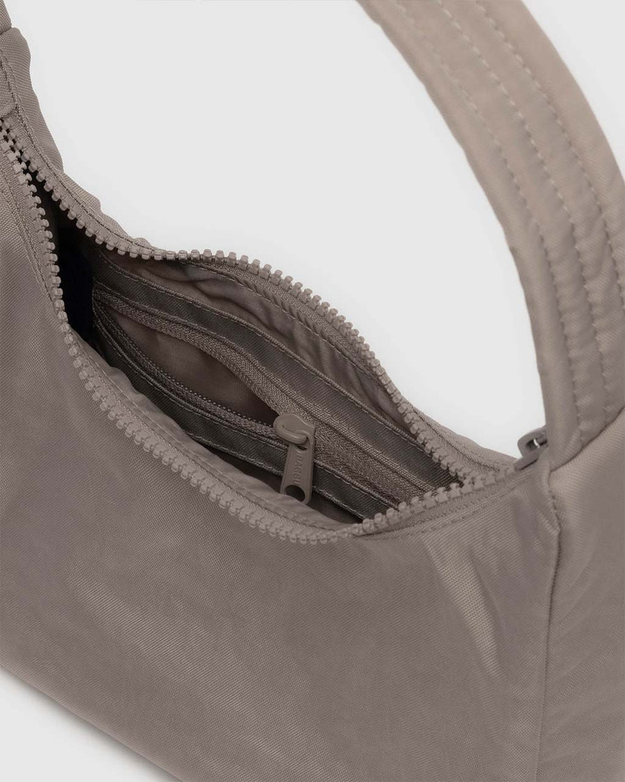 interior pocket of taupe mini nylon shoulder bag