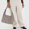 model holding taupe nylon shoulder bag