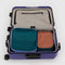 set of two packing set with canyon, cornflower, and cypress color blocking in a suitcase