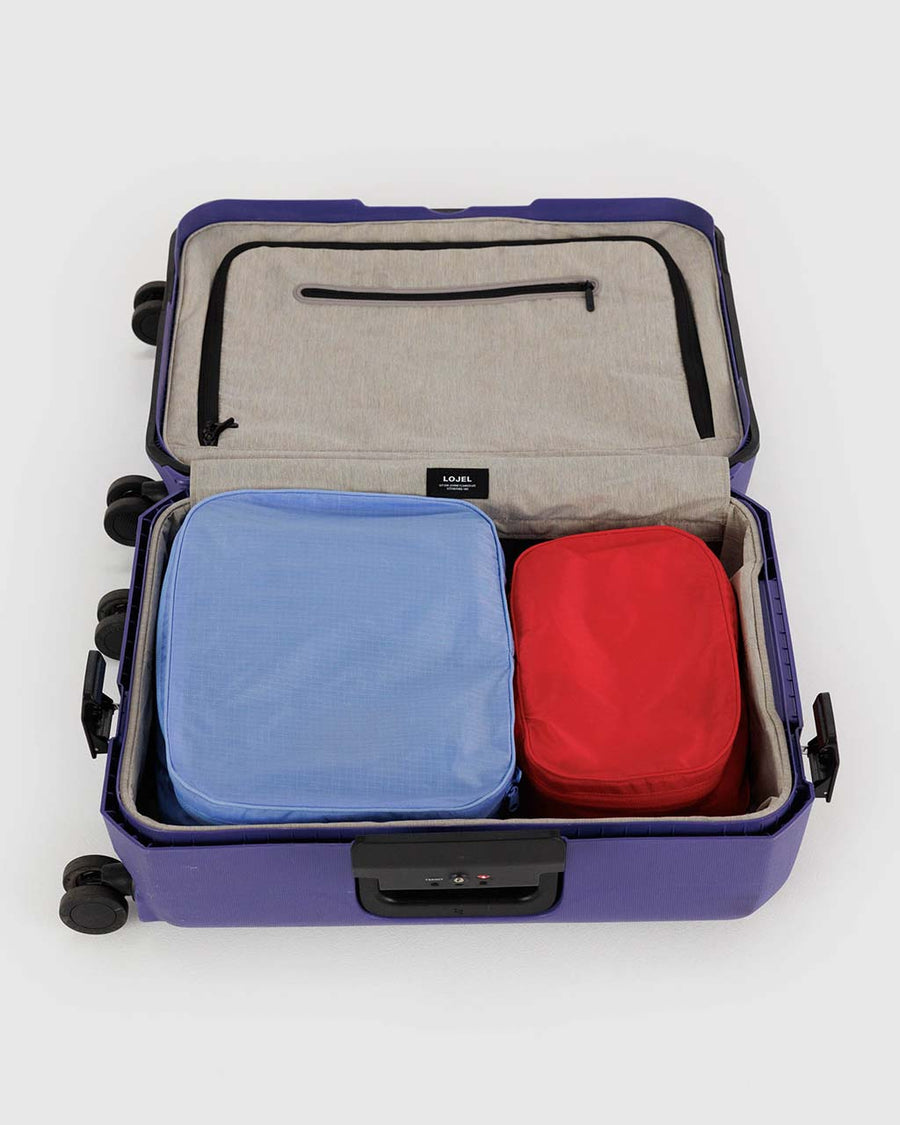 set of two nylon packing cube set: red small and cornflower large in a suitcase