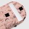 pink 13 in. puffy laptop sleeve with various icons (moon, ballet shoes, spider, moons, snake, roses) with laptop inside