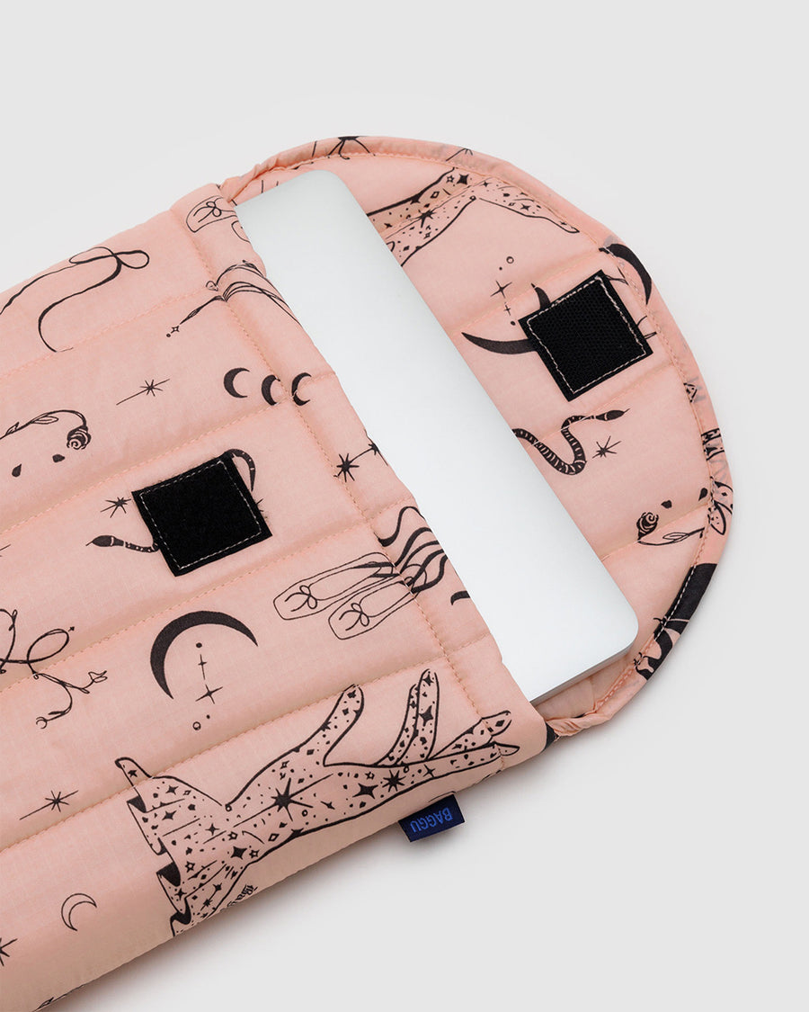 pink 13 in. puffy laptop sleeve with various icons (moon, ballet shoes, spider, moons, snake, roses) with laptop inside