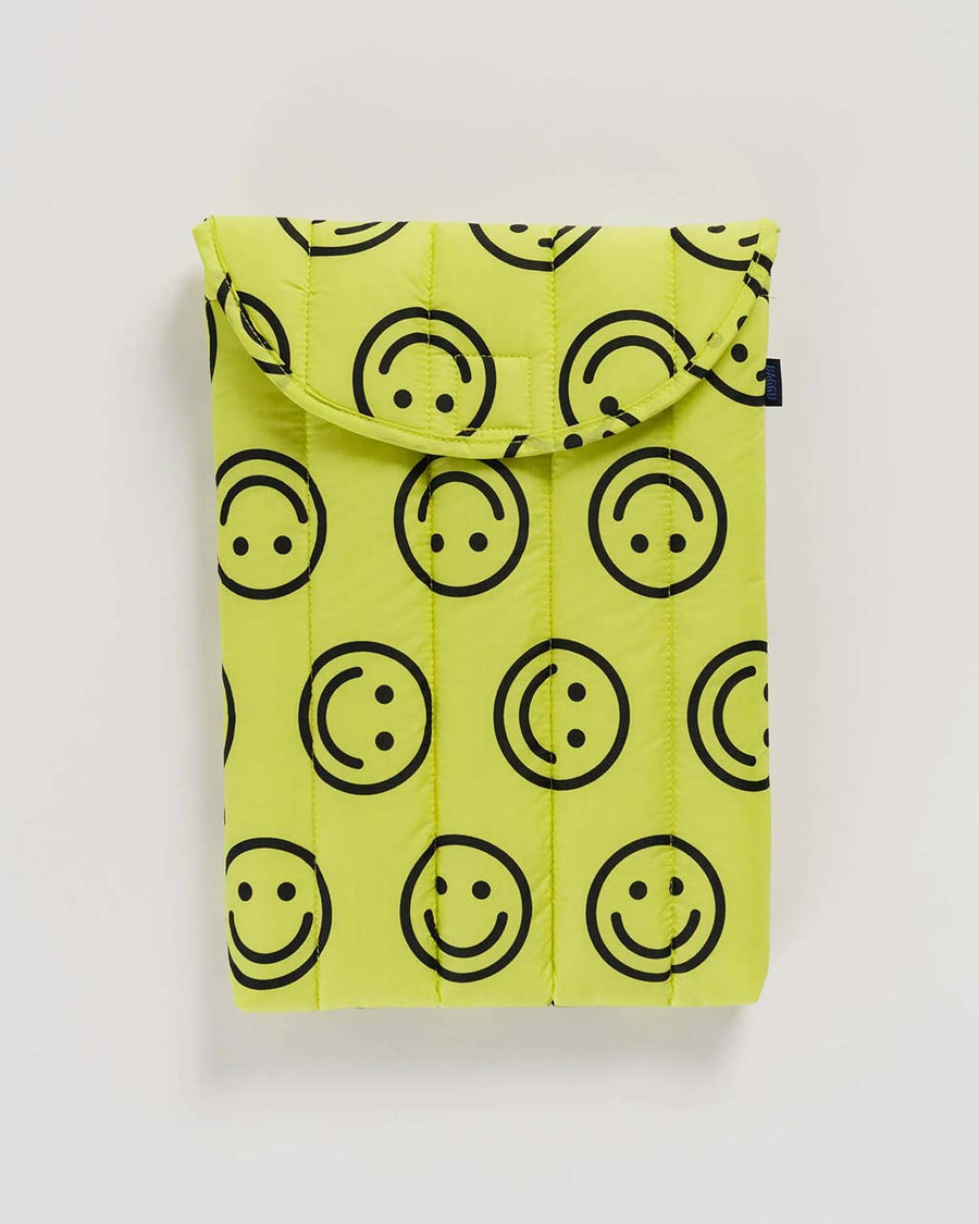 yellow 13" puffy laptop sleeve with black all over smiley face print