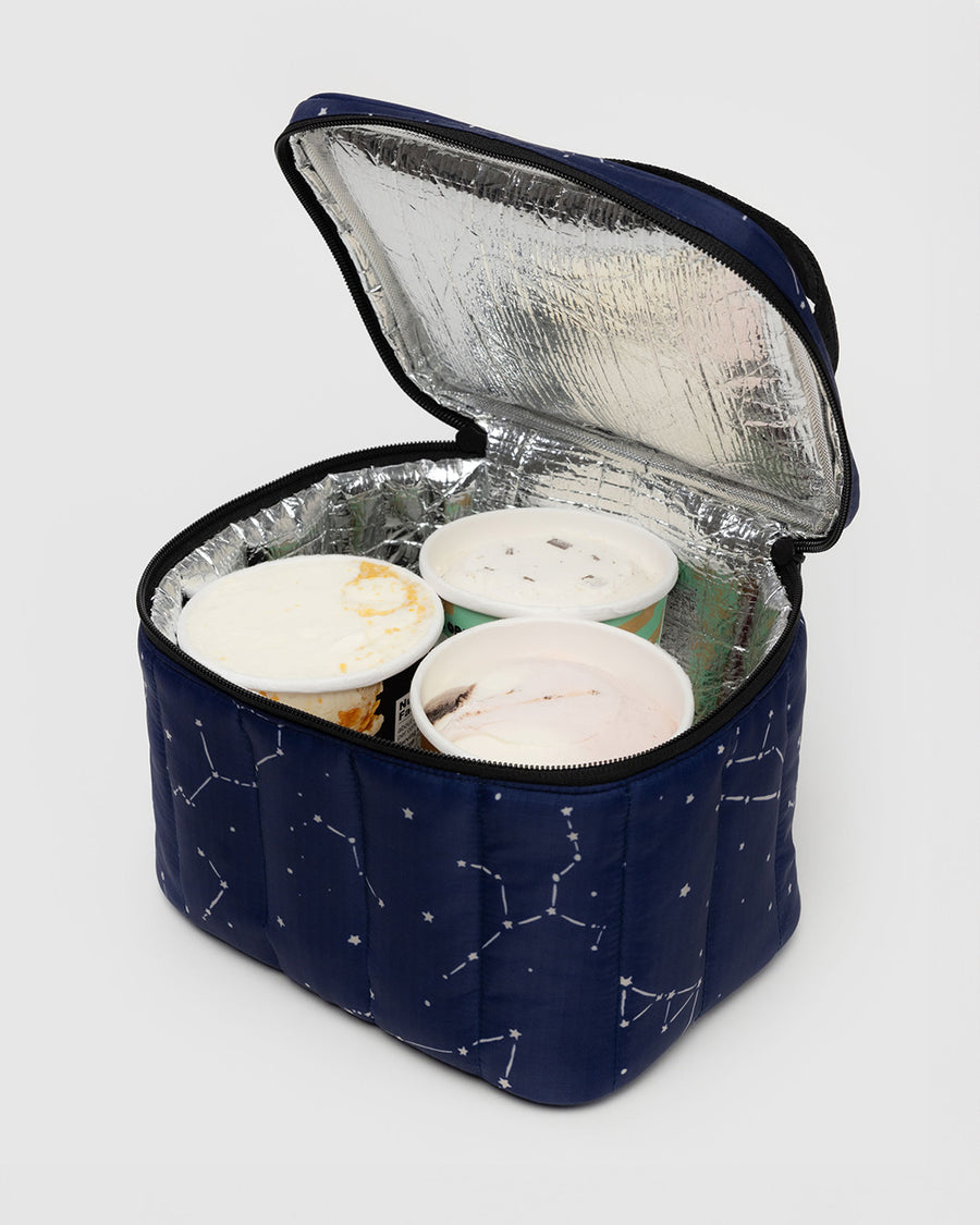 navy puffy lunch bag with white constellation print with ice cream inside