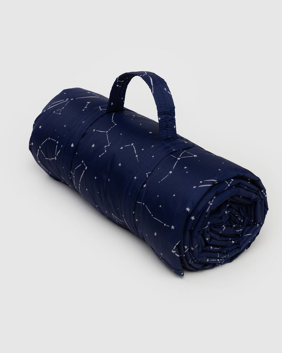 navy puffy picnic blanket with white constellation print