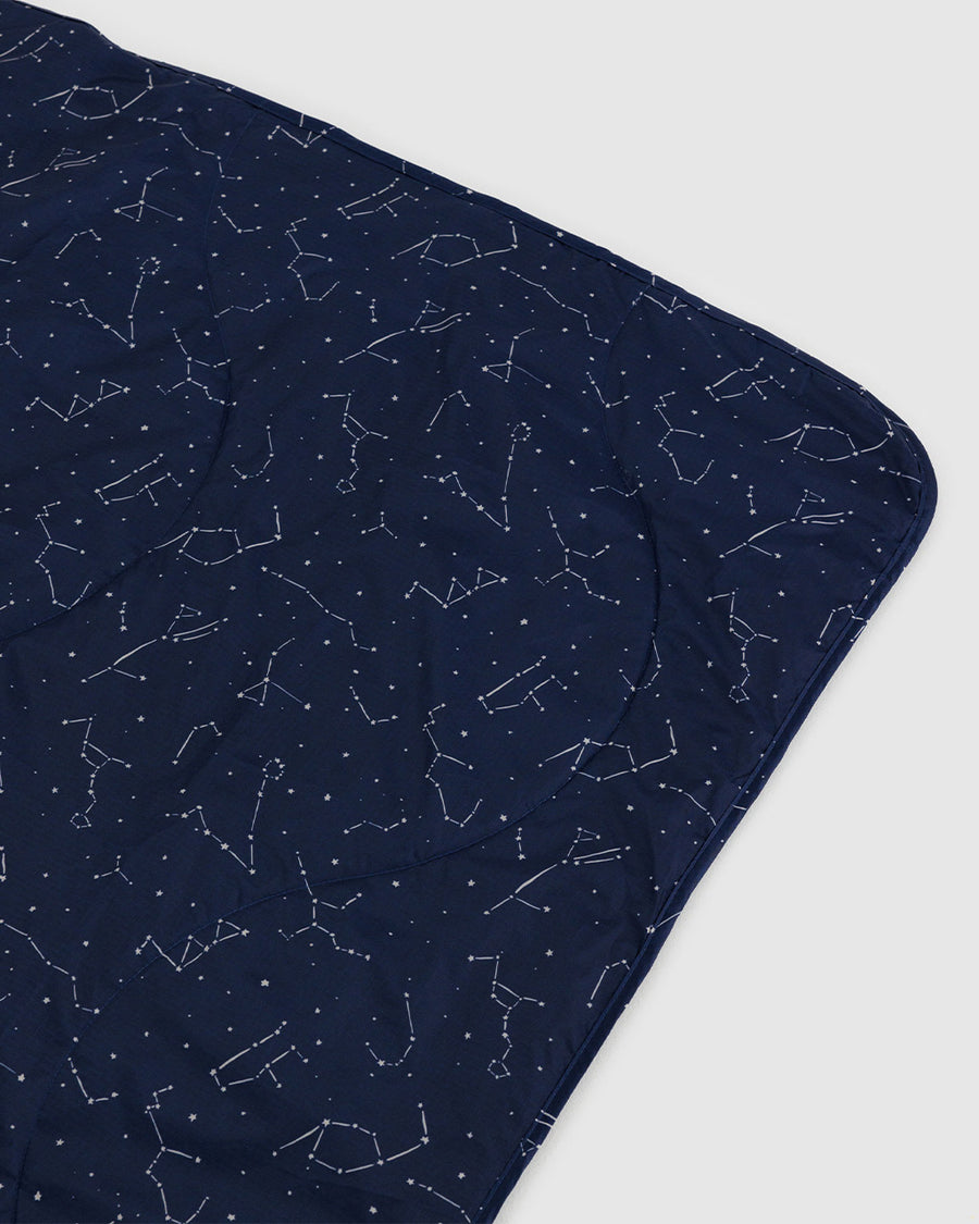 up close of navy puffy picnic blanket with white constellation print