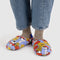 model wearing cornflower puffer slippers with snoopy and red and yellow flower print