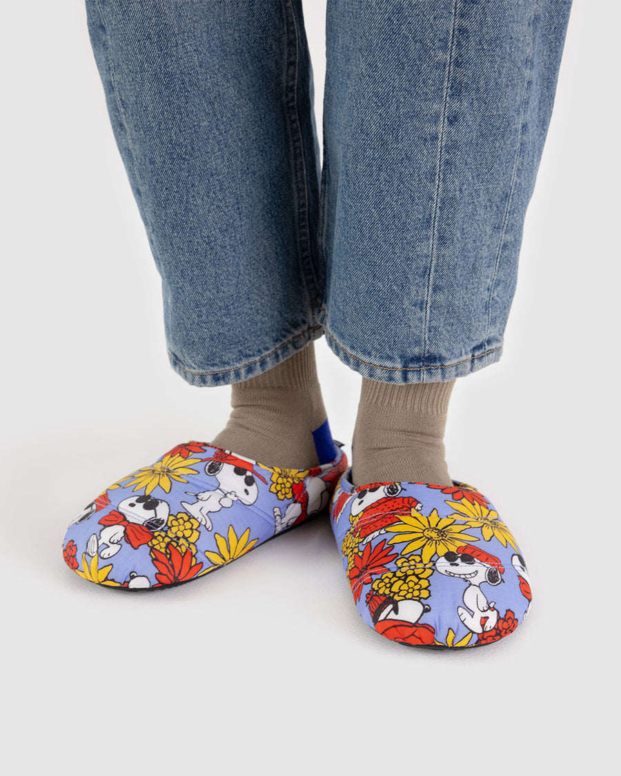 model wearing cornflower puffer slippers with snoopy and red and yellow flower print