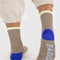 back view of taupe ribbed socks with bright red, blue and pale yellow trim