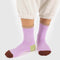 model wearing peony ribbed socks with taupe, lime, and burgundy trim