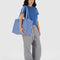 model carrying cornflower small cloud carry on bag