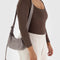 model wearing taupe small nylon crescent bag