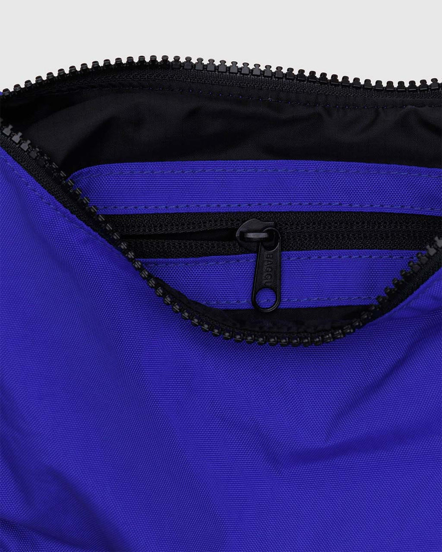 interior pocket of bright blue small nylon crescent bag