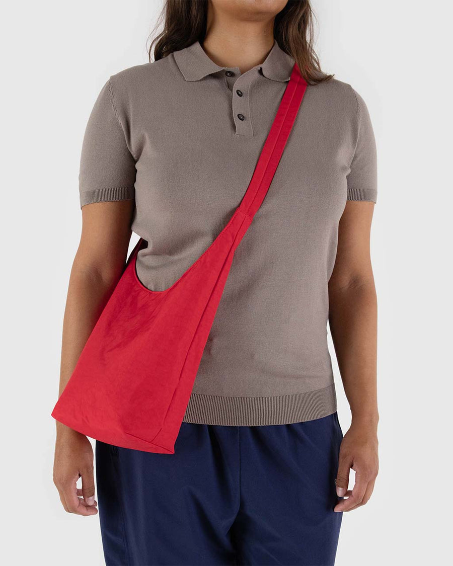 model wearing candy apple small nylon sling bag