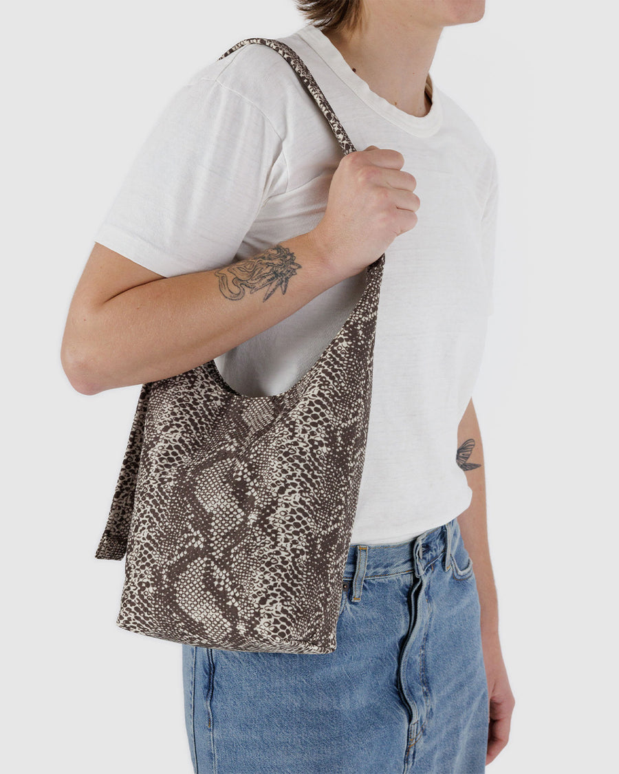 model carrying grey snakeskin small sling bag