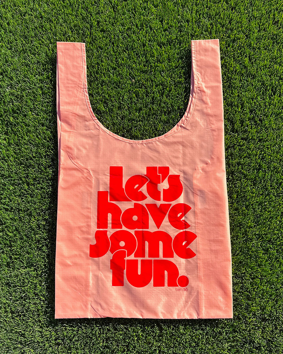 pink standard baggu with red 'lets have some fun' across the front