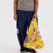 model holding yellow standard baggu with colorful cake/pastry print