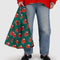 model holding green standard baggu with snoopy in a red puffer coat