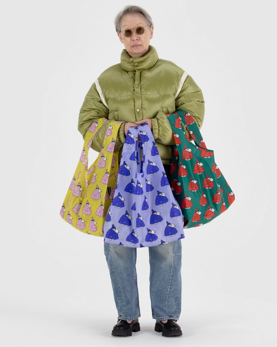 model holding set of three standard baggu bags: yellow snoopy puffer, blue snoopy puffer and green snoopy puffer