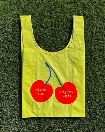 yellow standard baggu with red cherries and 'you're the cherry best' across the front