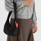 model carrying black swan shoulder bag