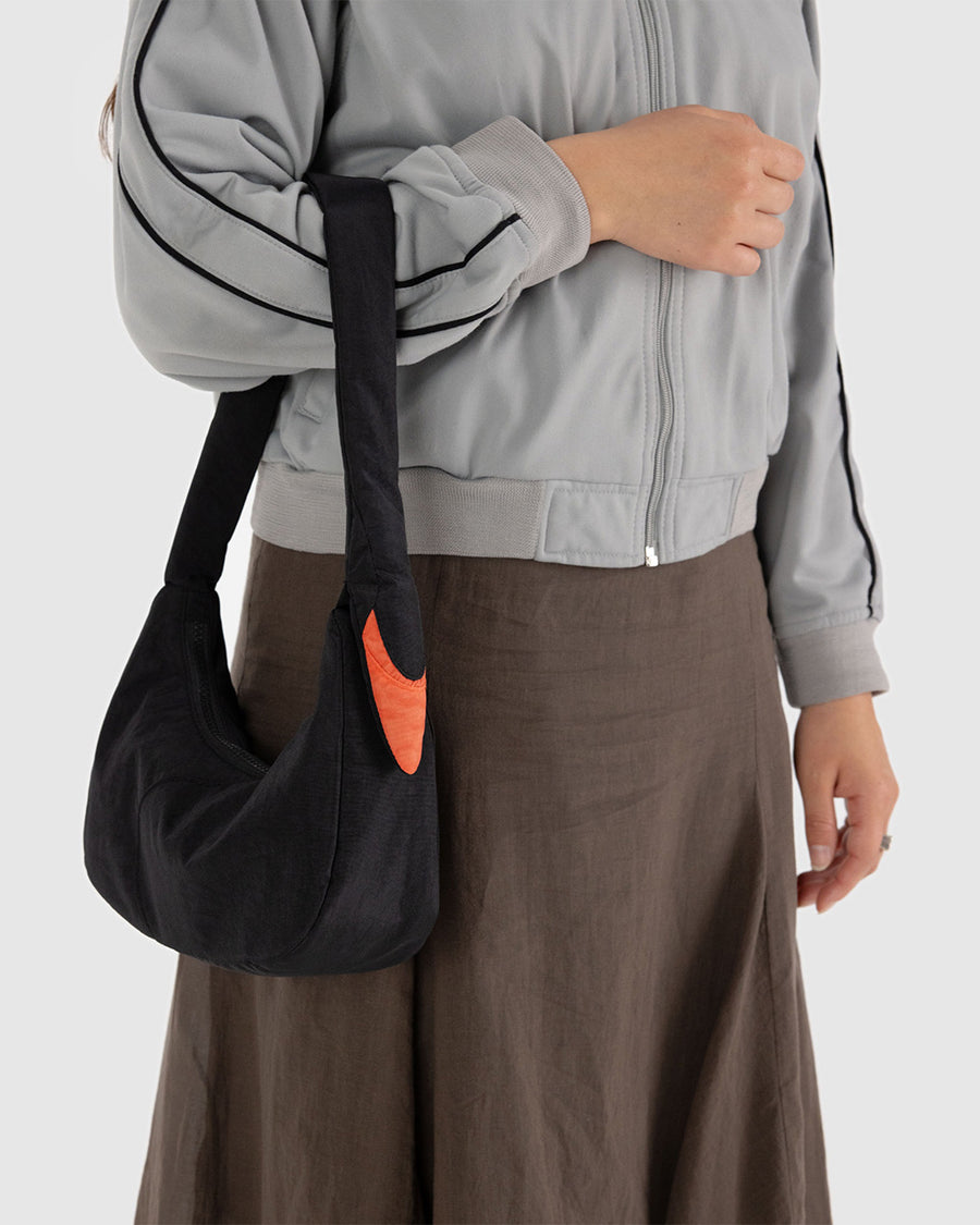 model carrying black swan shoulder bag