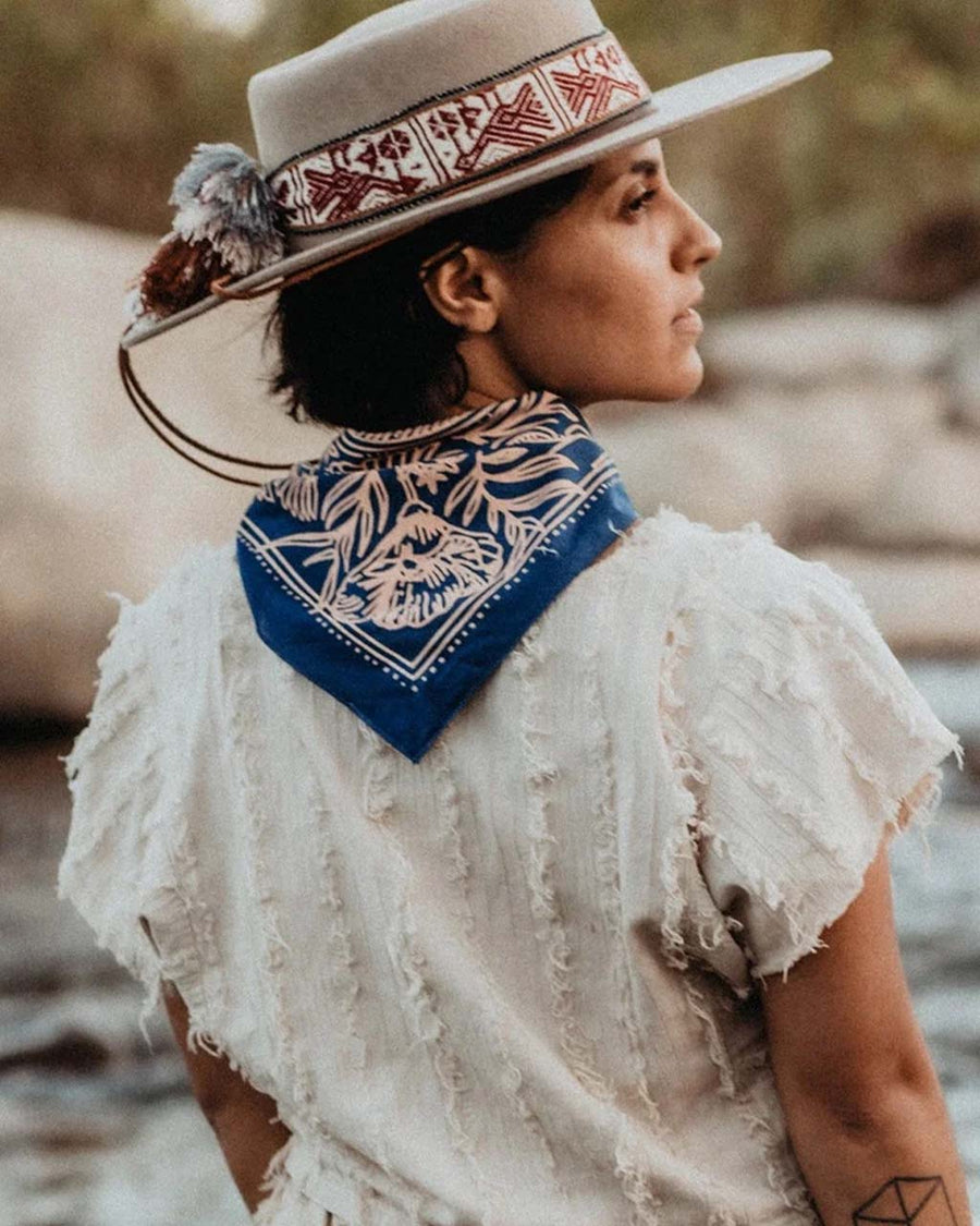 back view of blue square bandana with pink mountain scene and floral print