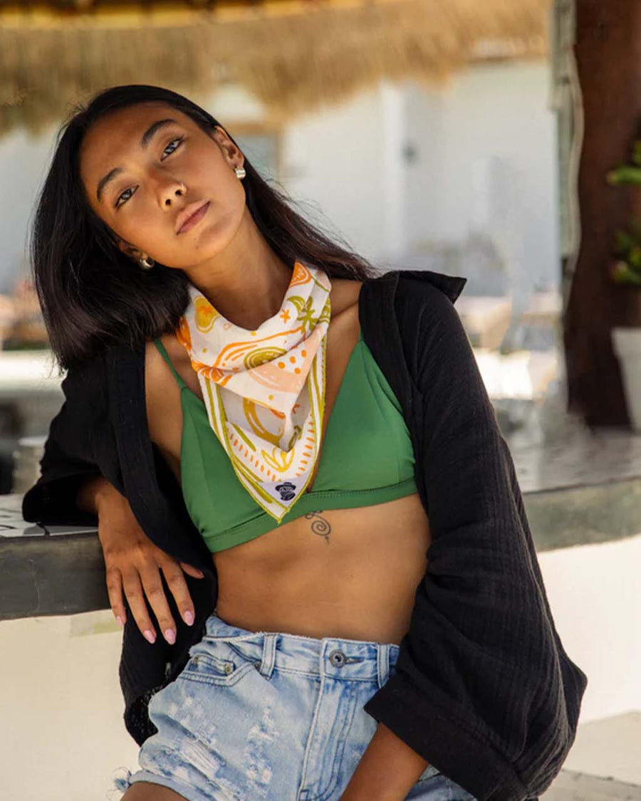 model wearing square cotton bandana with abstract banana, orange, papaya print