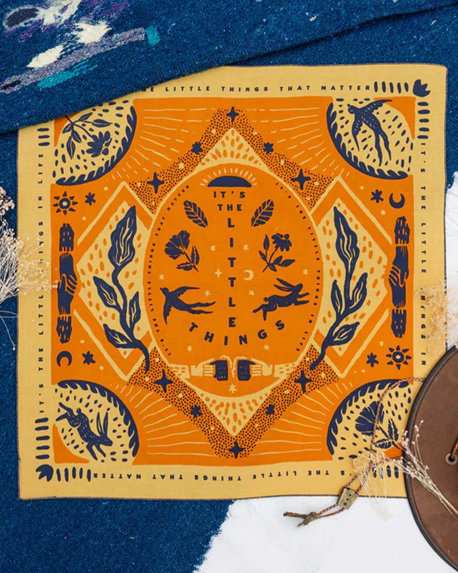 yellow and orange cotton bandana with blue bird print and 'it's the little things' in the center