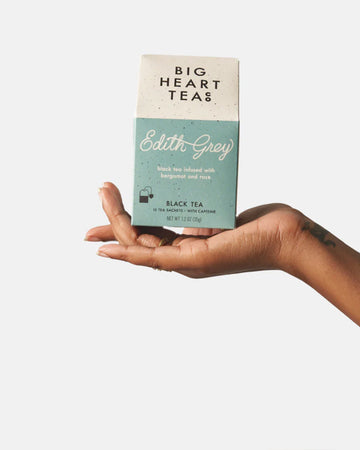 model holding set of 10 black tea infused with bergamot and rose tea bags