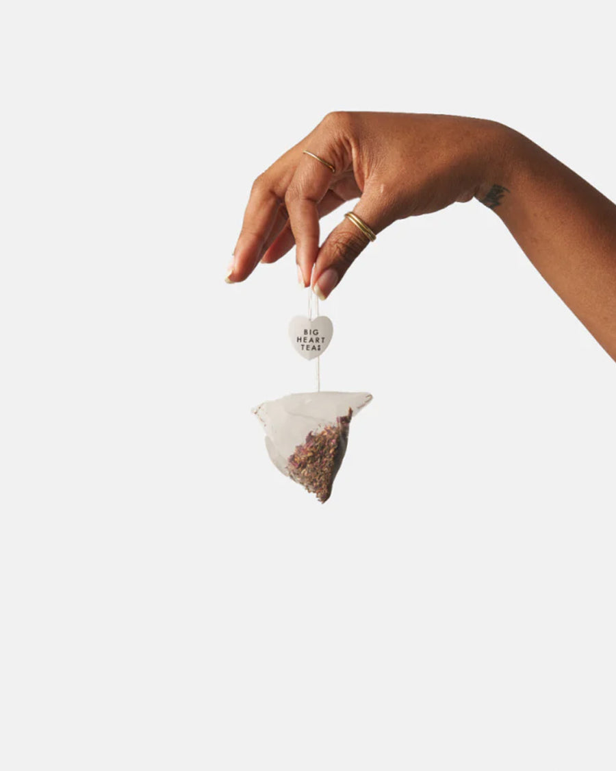 model holding tea bag