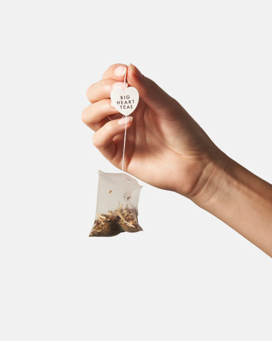 model holding tea bag