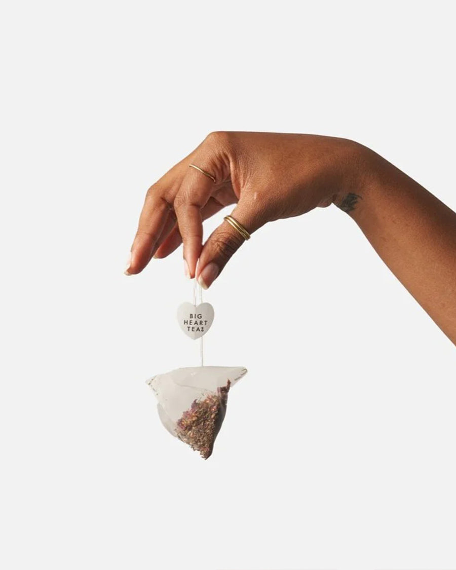 model holding tea bag