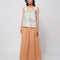model wearing pink and yellow gingham maxi skirt with smocked waist and side pockets