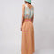 back view of model wearing pink and yellow gingham maxi skirt with smocked waist and side pockets